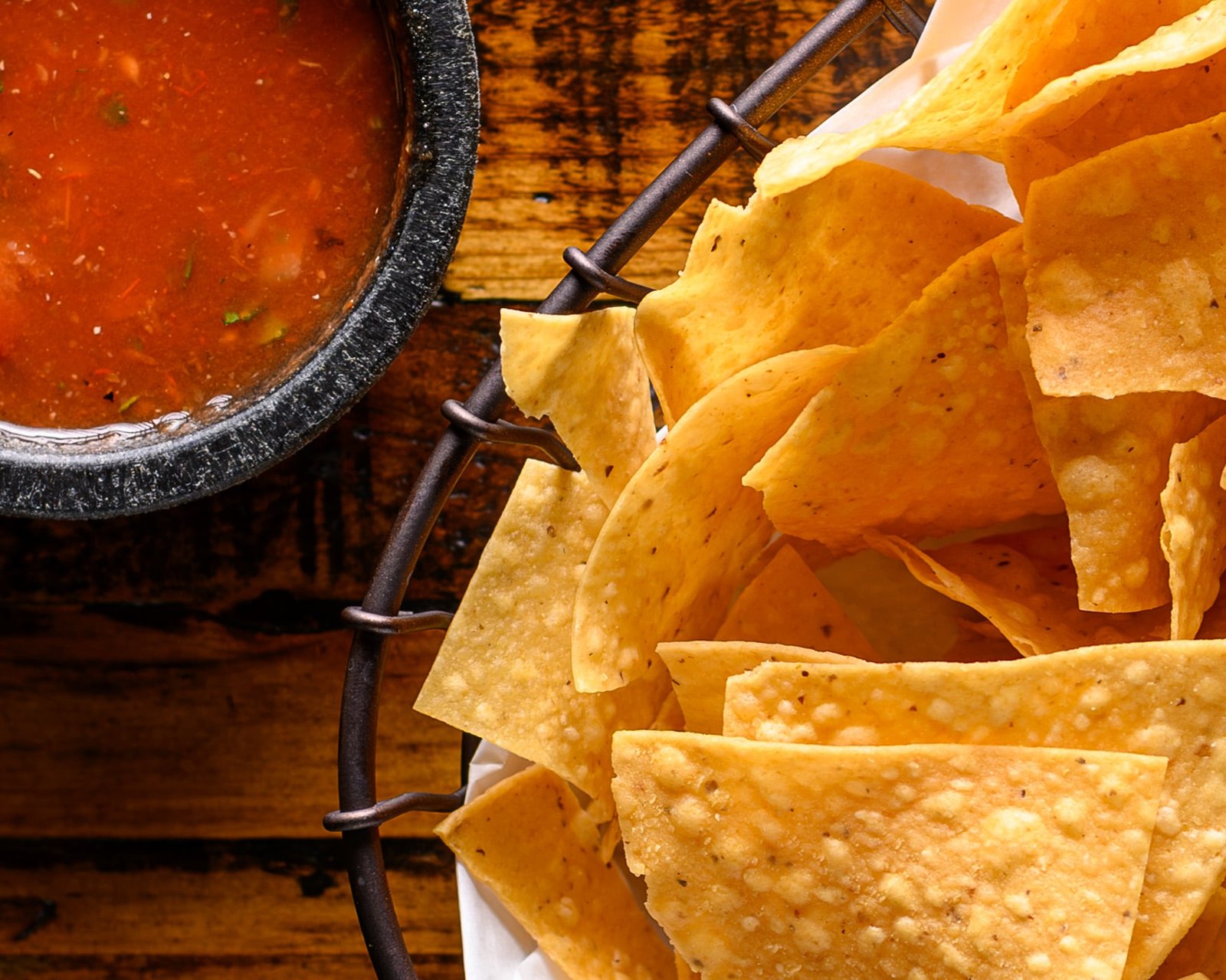 A basket of warm tortilla chips with Don Perico house salsa